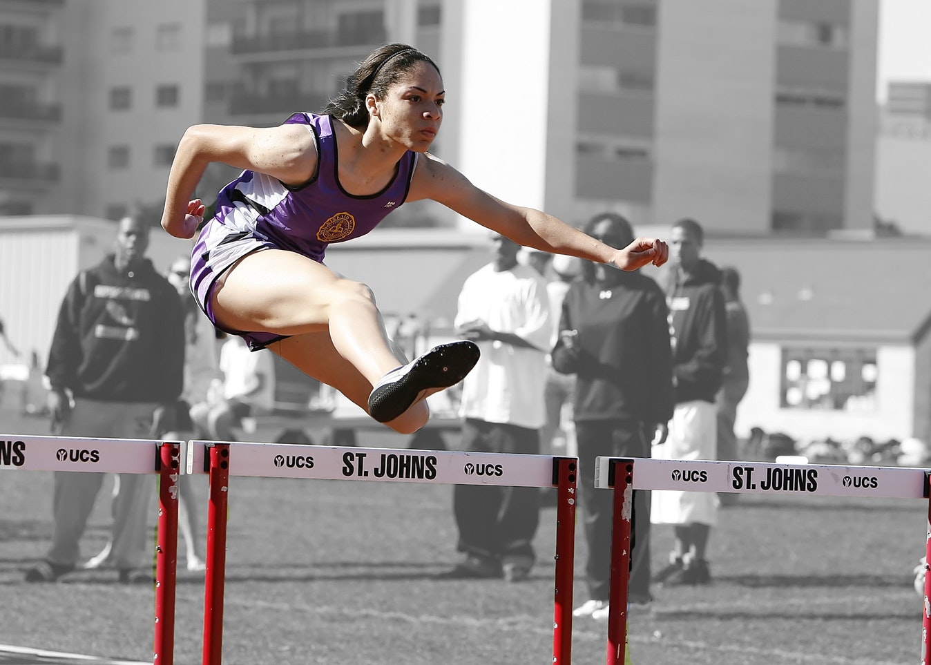 woman jumping hurdles